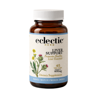 Bottle of concentrated herbal liver support supplement with milk thistle, dandelion, and turmeric ingredients
